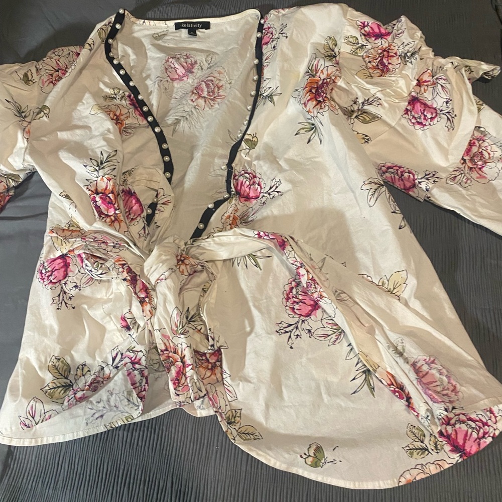 Wrap blouse with pearl detail on the cuff sleeves and the front.